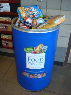 a blue trash can with food in it