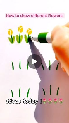 someone is drawing flowers on the paper with a green marker and some pink tulips