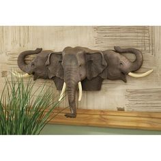 an elephant head mounted to the side of a wall