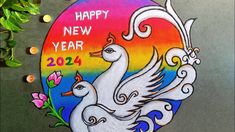 a happy new year sign painted on the side of a building with two white birds