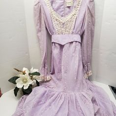 Fabulous Dress So Cottagecore Piraire Victorian Look (Out Of Little House On The Piraire) Or At The Time Of Sitting And Having A Stroll In The Garden With Tea Time And Scones Bridgerton Movie Based By Kveta Sherman Oaks Light Purple Lavender Lilac Soft Color But The Dress Has Stains In Different Places (Last Picture Example) Hard To Show With Tinney Little Floral Flowers All Over (Feels Like Flocked Material) Lace Upper & Neckline & End Of Sleeves (Gorgeous) Trimmed In Satin Ties At The Back Bel Purple Victorian Dress, Sherman Oaks, Fabulous Dresses, Purple Lavender, Little House, Flower Dresses, Scones, Floral Flowers, Flocking