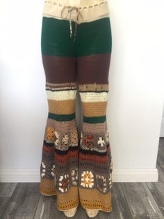 the legs of a woman wearing multicolored knitted pants