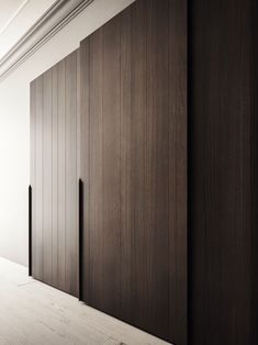 an empty room with wooden doors and white walls