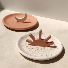 two plates with shapes on them sitting on a table