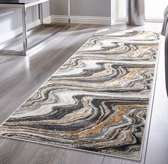 an area rug in the middle of a room with a chair and desk behind it