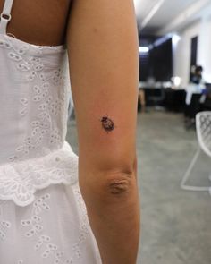 a woman with a small tattoo on her arm