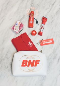 an assortment of personal items laid out on a marble counter top with the bnf logo