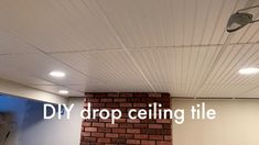 a brick fireplace with the words diy drop ceiling tile on it's side