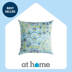 a blue and green pillow with the words best seller at home in front of it