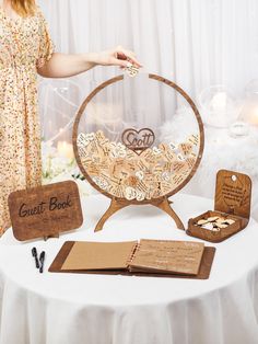 a table that has some kind of wooden book on it with other items around it