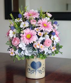 a vase filled with lots of pink and white flowers