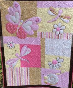 a pink and brown quilt with butterflies on it