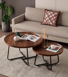 two coffee tables sitting on top of a rug in front of a couch and table