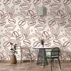 a room with a table and chairs in front of a wallpapered background that has leaves on it