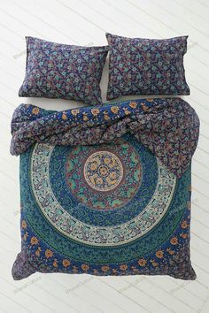 a blue and green bed with two pillows