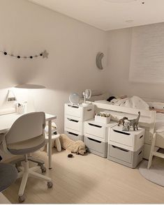 a bedroom with white furniture and lots of drawers on the floor in front of a bed