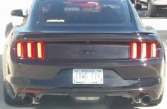 the rear end of a car parked in a parking lot