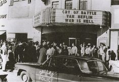 an old black and white photo of people in front of a movie theater