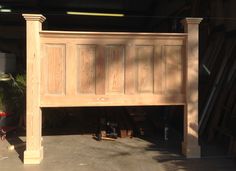 a wooden bed frame in the middle of a garage