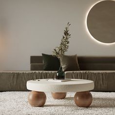 a living room with a couch, coffee table and round mirror