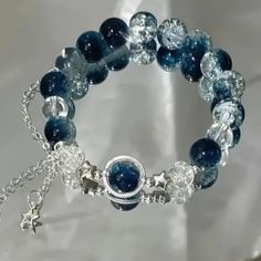 a bracelet with blue glass beads and silver charms