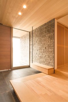 an empty room with wooden walls and flooring in front of a sliding glass door