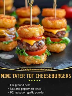 mini tater tot cheeseburgers on a black plate with toothpicks