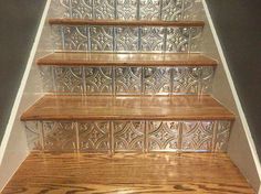 an image of some stairs that are made out of wood and glass tiles with the caption fax in ceiling tiles cut and used as stair risers