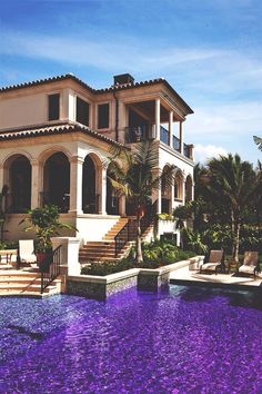 a large house with a pool in front of it