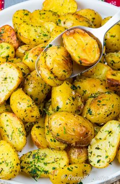 a white plate topped with potatoes covered in seasoning