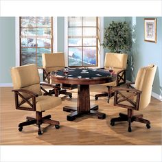 a dining room table with four chairs around it