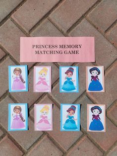 princess memory matching game on the ground with pictures of princesses and their names pinned to them