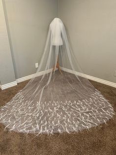 a woman is standing on the floor with a veil over her head