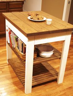 a kitchen island with bookshelves and plates on it