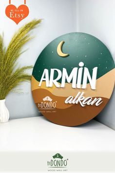 a round wooden sign that says armin akan with the moon in the background