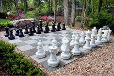 a giant chess set up in the middle of a garden