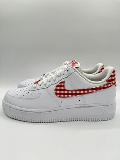 Elevate your sneaker game with these Nike Women's Air Force 1 07 Low ESS Trend in size 9. These shoes feature a stylish plaid pattern in white and red that effortlessly blends with any outfit. With a lace-up closure and low-top shaft style, these sneakers provide a comfortable fit that you can adjust to your liking. Designed to perform, these athletic shoes are lightweight, cushioned, and breathable, making them perfect for any season and activity. Whether you're going to the gym, walking around town, or doing some cross-training, these Nike Air Force 1 sneakers are sure to provide the comfort and performance you need. Made with high-quality leather and a durable rubber outsole, these shoes are built to last. Air Force 1 Sneakers, Nike Air Force 1 07, Cute Nikes, Sneaker Games, Red Gingham, Red Outfit, Athletic Fits, Going To The Gym, Cross Training