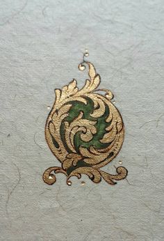 an intricately designed piece of paper with gold and green designs on it's edges