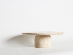 a white table sitting on top of a white floor