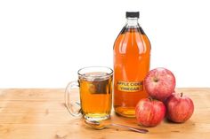 an apple cider and some apples on a table