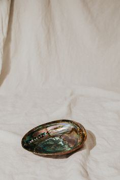 an empty bowl sitting on top of a white sheet