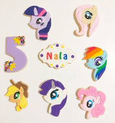 the cookies are decorated to look like little ponys and have numbers on them that spell out their names