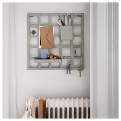 a room with a radiator, bookshelf and other items on the wall