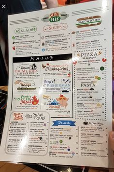 a person holding up a menu for a restaurant