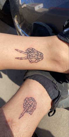 two people with matching tattoos on their arms