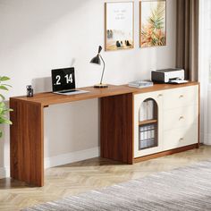 a desk with a clock on it in front of a window and a plant next to it