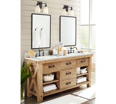 a bathroom with two sinks and mirrors on the wall