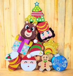 a group of stuffed animals sitting on top of a wooden table next to each other