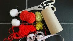 yarn, scissors and thread laid out on top of a black surface with white trim