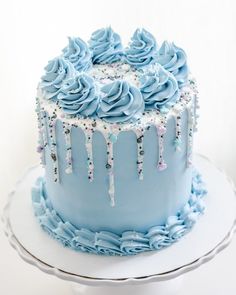 a blue frosted cake with icing dripping from it